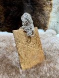 Load image into Gallery viewer, Silver flower ring on wood block with fur background