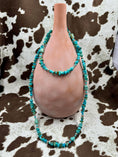 Load image into Gallery viewer, Sterling Silver and Turquoise Chip Chunk Bead Necklace on brown bottle with cowhide background