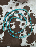 Load image into Gallery viewer, Sterling Silver and Turquoise Chip Chunk Bead Necklace on cowhide background