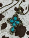 Bild in Galerie-Betrachter laden, Faux Turquoise Cross on cowhide background