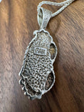 Bild in Galerie-Betrachter laden, Back of Turquoise Leaf Pendant on brown block showing makers mark