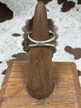 Load image into Gallery viewer, Back view of turquoise flower ring on wood stand with cowhide background