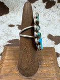 Load image into Gallery viewer, turquoise flower ring on wood stand with cowhide background