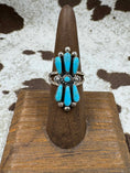 Bild in Galerie-Betrachter laden, butterfly turquoise ring on brown stand with cowhide background