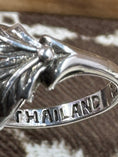 Load image into Gallery viewer, Inside of ring with cowhide background. Says Thailand on Ring