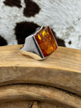 Load image into Gallery viewer, Sterling Silver Square Amber ring on wood block and cowhide background