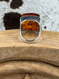 Load image into Gallery viewer, Backside of Sterling Silver Square Amber ring on wood block and cowhide background