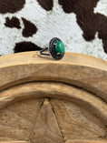 Load image into Gallery viewer, Green Onyx and Spinel Ring sitting on wood block and cowhide background