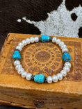 Load image into Gallery viewer, Vintage Simulated Pearl and Faux Turquoise Bracelet on leather box with cowhide background