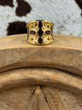 Load image into Gallery viewer, Vintage Gold Plated Cross Ring with Garnets on wood block with cowhide background