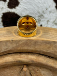 Load image into Gallery viewer, underside Vintage Gold Plated Cross Ring with Garnets on wood block with cowhide background