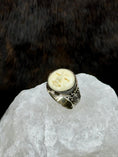 Load image into Gallery viewer, Bali Bone Ring "Face of the Moon" on white rock with dark background