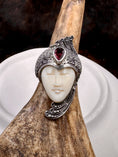 Load image into Gallery viewer, Bali Carved Bone Face Goddess Ring with Amethyst Colored Stone on moose antler with white and brown background
