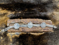 Load image into Gallery viewer, Chain Bracelet with Coins of George V on wood block with dark fur background
