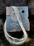 Load image into Gallery viewer, Southwest Style Polished Sterling Silver Liquid 10 strand Necklace on industrial stand with dark fur background