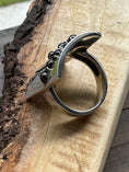 Load image into Gallery viewer, Back side of Garnet Adam and Eve Ring on wood block