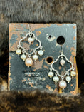 Load image into Gallery viewer, Pearl Chandelier Earrings on metal industrial stand on dark fur background