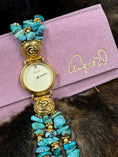 Load image into Gallery viewer, Vintage Angie Dickinson Turquoise Watch on pink pouch on dark fur background