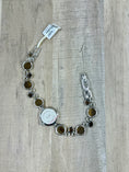 Load image into Gallery viewer, Back of Tigers Eye and Sterling Silver Watch on wood background