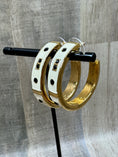 Load image into Gallery viewer, QVC Kenneth Jay Lane Enamel Statement Hoop Earrings on black stand with wood background