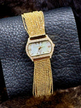 Load image into Gallery viewer, Peugeut Gold and Crystal Ladies Watch laying on leather background