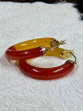 Load image into Gallery viewer, 14K Yellow Gold and Bi-Color Jade Hoop Earrings on cowhide