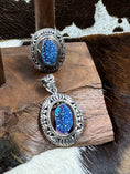 Load image into Gallery viewer, Druzy Blue Quartz and Sterling Silver Ring and Pendant on wood block with cowhide background