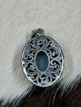 Load image into Gallery viewer, Druzy Blue Quartz and Sterling Silver Pendant on cowhide background