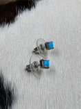 Load image into Gallery viewer, Vintage Sterling Silver and Turquoise Earrings on cowhide background