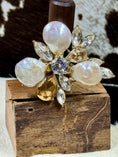 Load image into Gallery viewer, Faux Pearl and Crystal Flower Ring on wood block with cowhide background