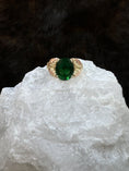 Load image into Gallery viewer, Black Hills Gold Coleman 10K Lab Created Emerald on white rock with fur background