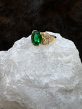 Load image into Gallery viewer, Side view Black Hills Gold Coleman 10K Lab Created Emerald on white rock with fur background
