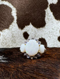 Load image into Gallery viewer, Tanzanite and Opal 10K Gold Ring on cowhide with cowhide background