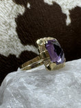 Load image into Gallery viewer, Vintage Amethyst and 14K Gold Ring on white rock with cowhide background