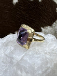 Load image into Gallery viewer, Vintage Amethyst and 14K Gold Ring on white rock with cowhide background