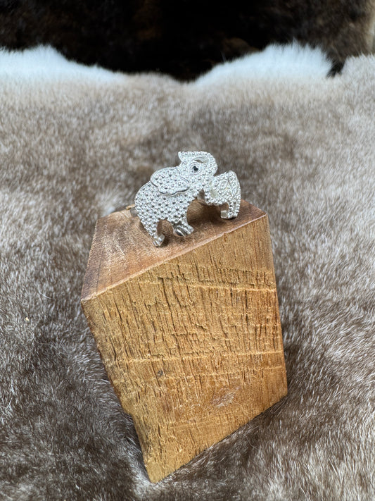 Elephant silver ring on wood block on fur background