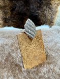 Load image into Gallery viewer, Silver leaf-shaped ring on a wooden stand with a fur background
