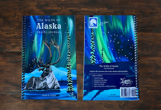 Front and back of the wilds of alaska travel journal with a caribou on the front and northern lights. 