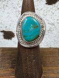 Load image into Gallery viewer, Vintage Sterling Silver and Turquoise Ring on wood stand with cowhide background
