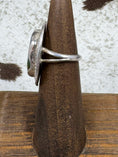 Load image into Gallery viewer, Side view of Vintage Sterling Silver and Turquoise Ring on wood stand with cowhide background
