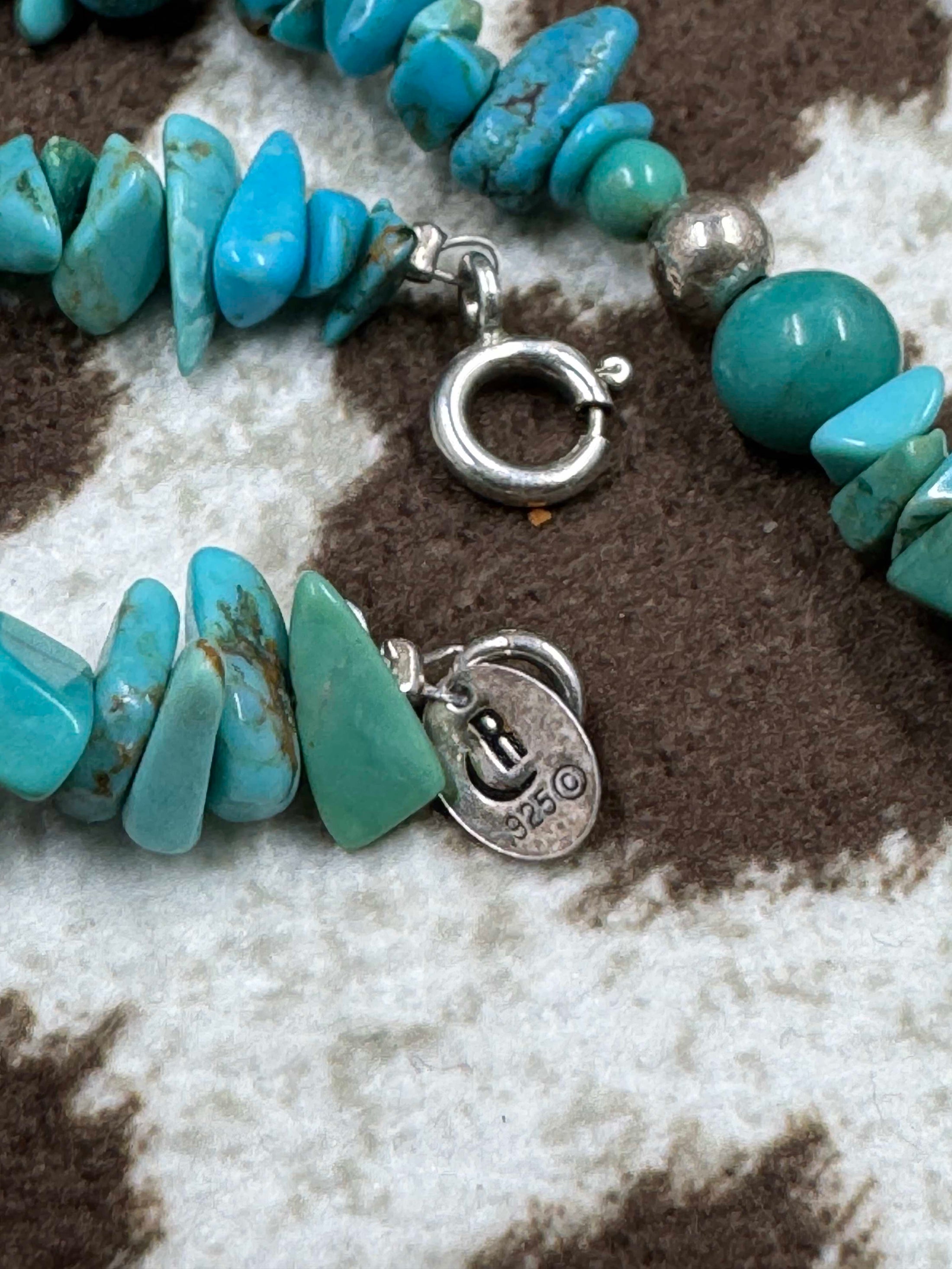 Sterling Silver and Turquoise Chip Chunk Bead Necklace showing makers mark on cowhide background