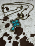 Load image into Gallery viewer, Faux Turquoise Cross on cowhide background
