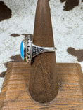 Bild in Galerie-Betrachter laden, Side view of Southwestern Moonstone Turquoise and Sterling Silver Oval Ring on a brown stand with cowhide background
