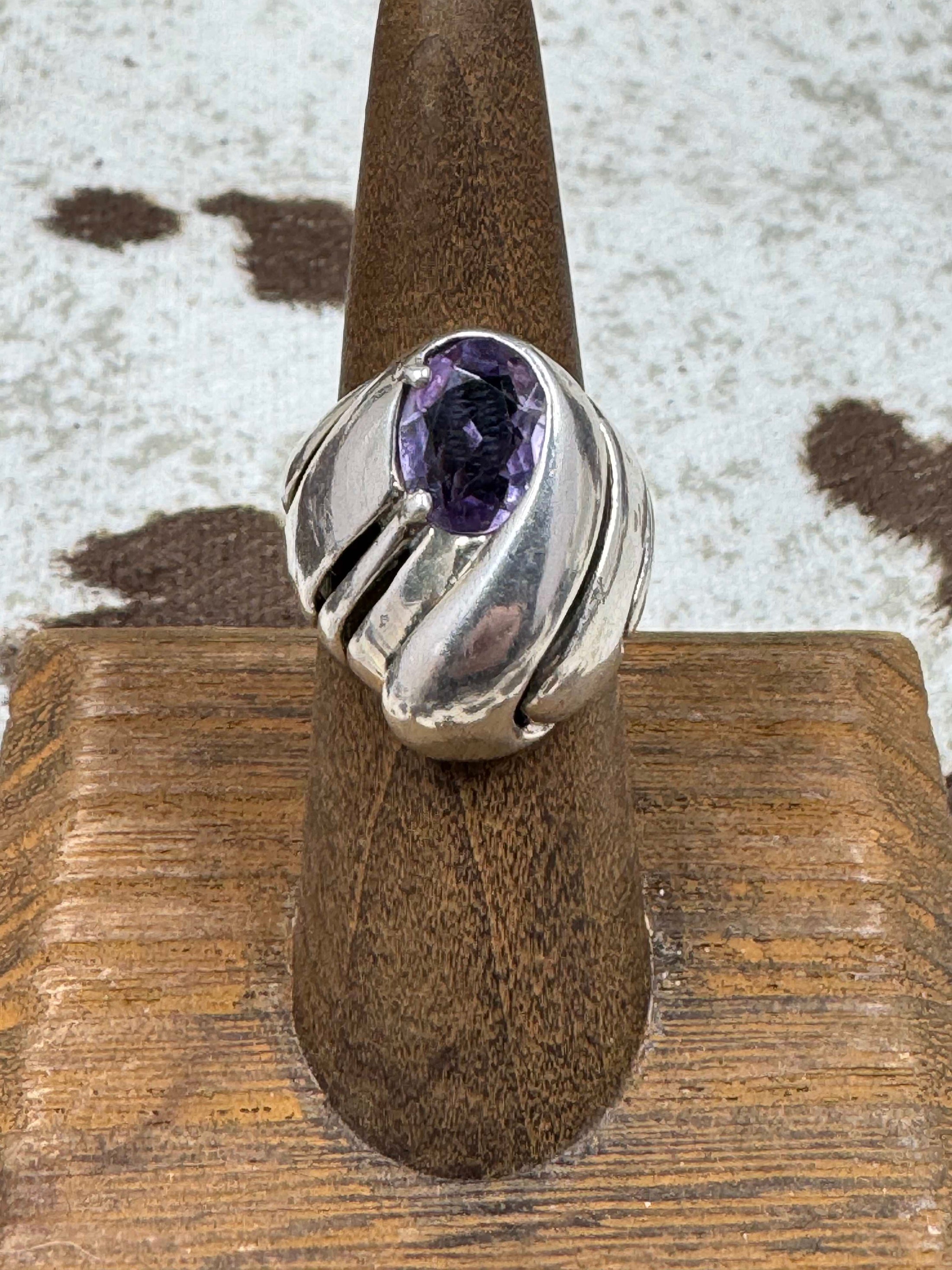 Vintage Kabana Amethyst Dome Ring on brown stand with cowhide background