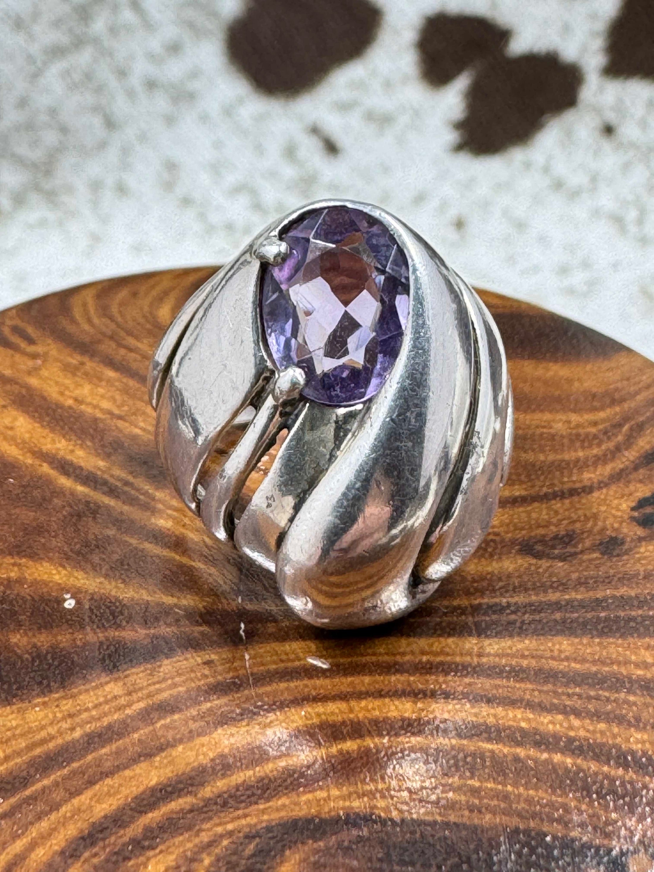 Vintage Kabana Amethyst Dome Ring on brown block with cowhide background