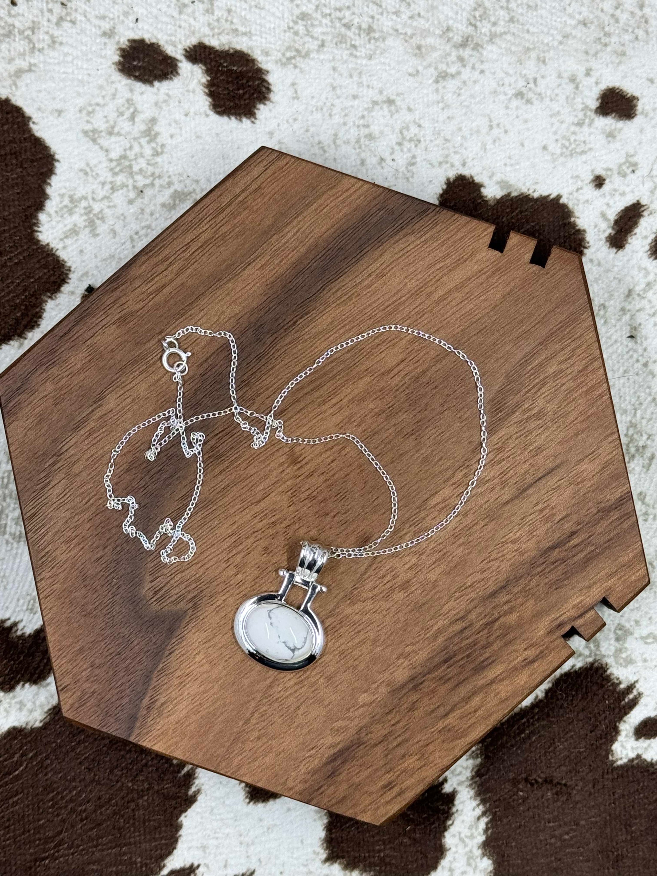 Sterling SIlver FAS White Howlite Necklace on wood block with cowhide background