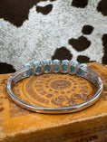 Bild in Galerie-Betrachter laden, Inside of Silver Hinged Bangle Bracelet with Larimar Cabochons on leather jewelry box with cowhide background
