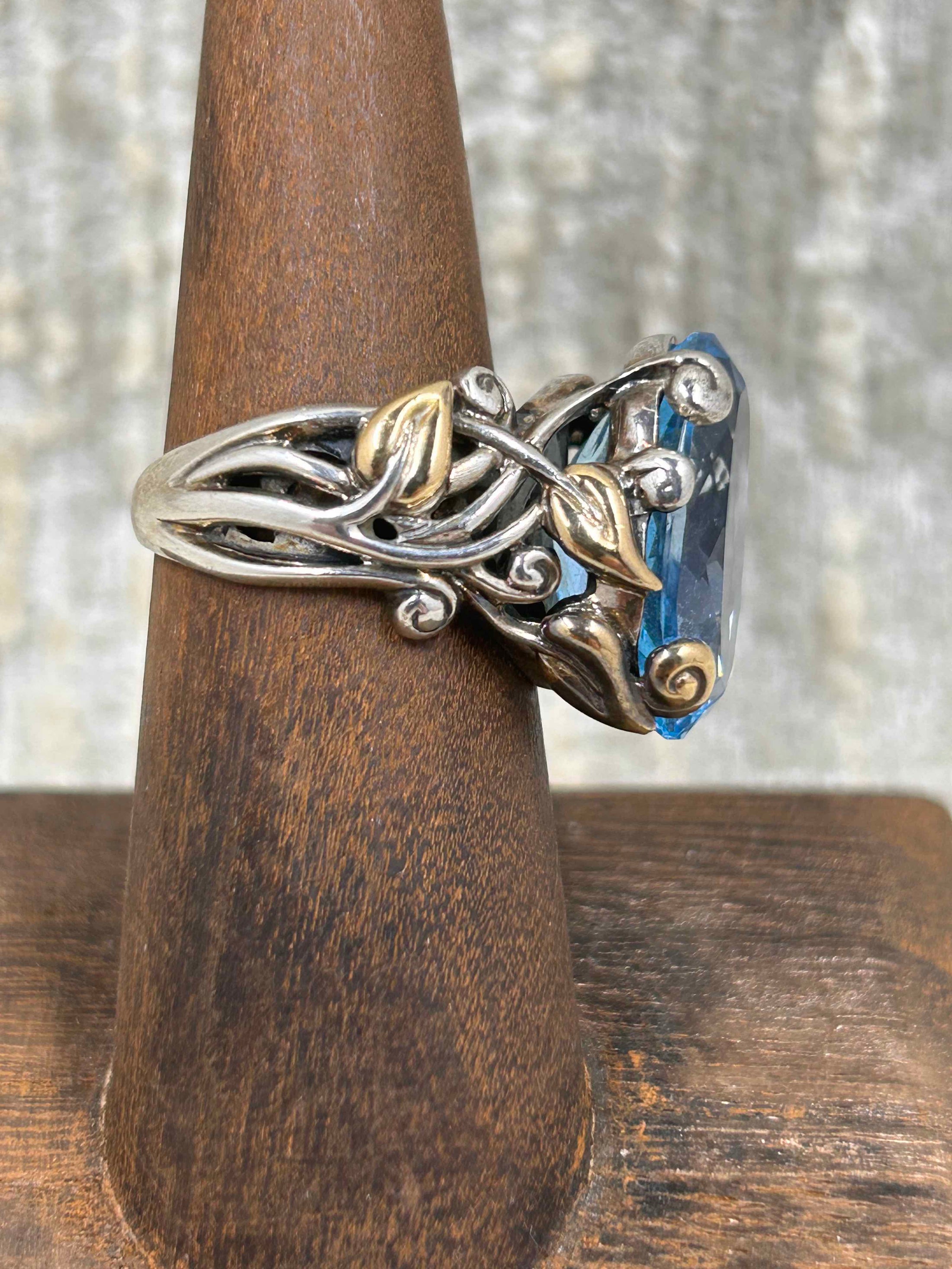 Side view of Sterling Silver and 18K Gold, this blue topaz ring by Barbara Bixby is stunning. Vintage