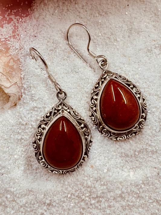 Carnelian Earrings laying in the sand