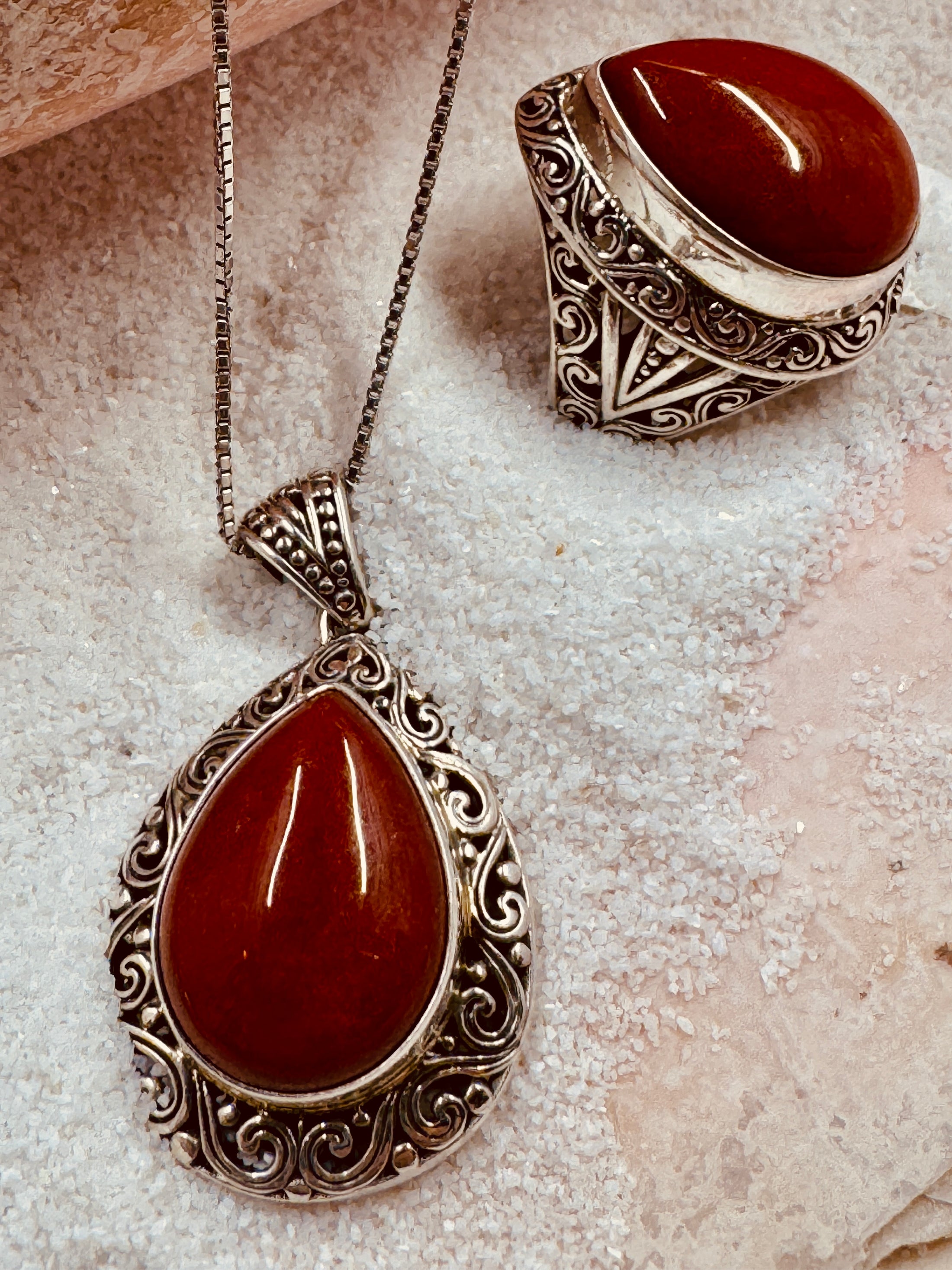 Carnelian Ring and Necklace Set laying in the sand